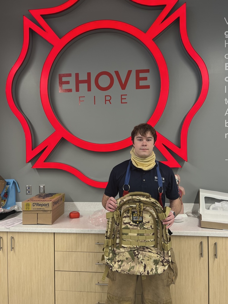 student holding backpack